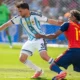 Lamine Yamal, en rouge avec l'Espagne, à la lutte avec l'Argentin Nicolas Tagliafico en finale du Mondial 2026