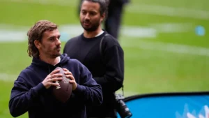Antoine Griezmann ballon de football américain en main lors d'un entraînement NFL à Madrid, novembre 2025