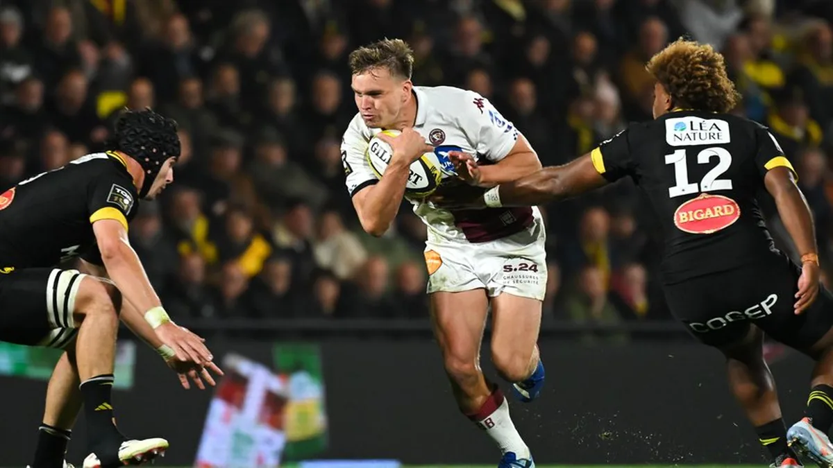 Un joueur de l'UBB ballon en main face à deux Rochelais à Deflandre lors de La Rochelle-UBB, octobre 2026